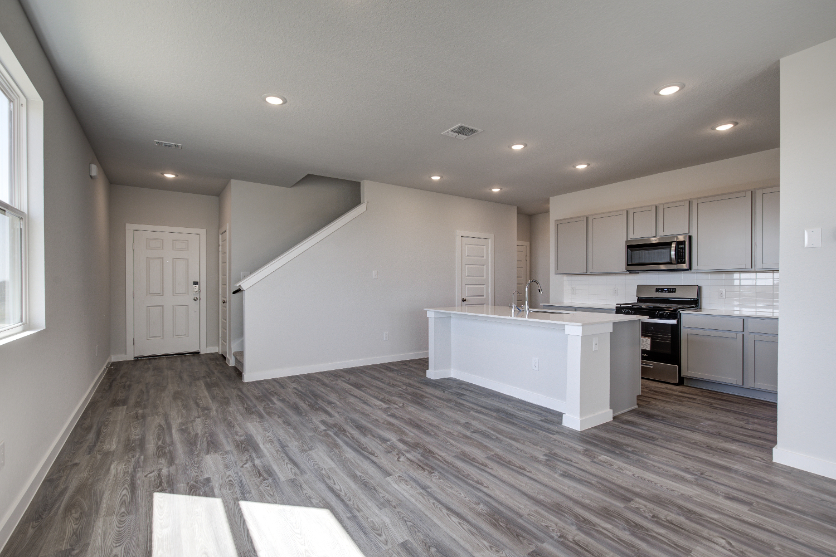 A kitchen with white cabinets.
