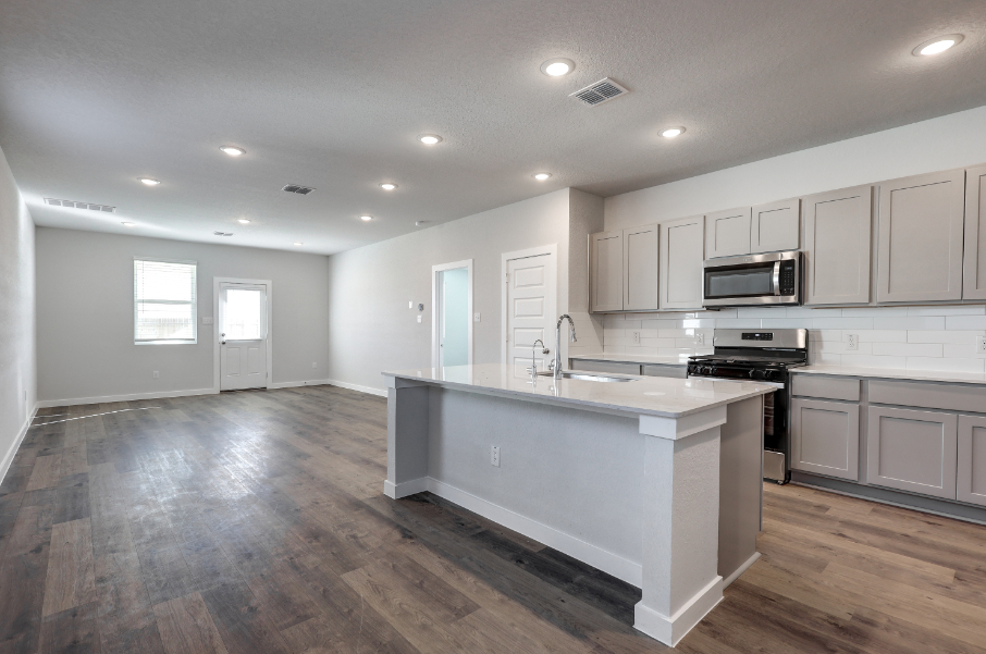 A kitchen with white cabinets.
