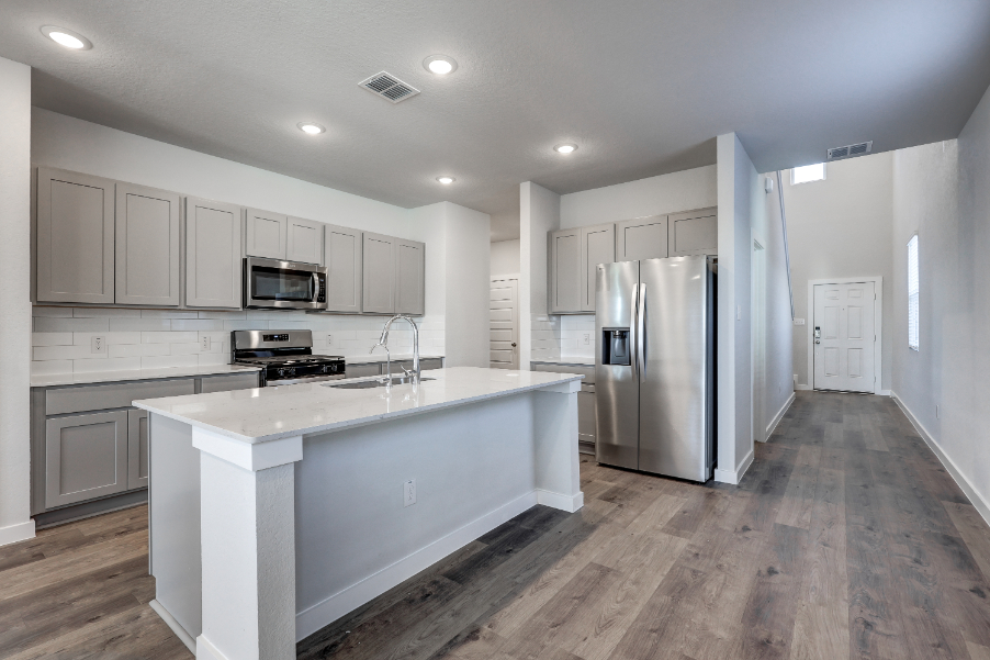 A kitchen with white cabinets.