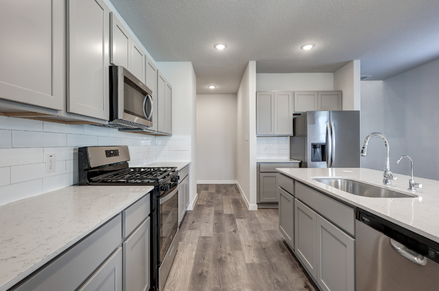 A kitchen with white cabinets.