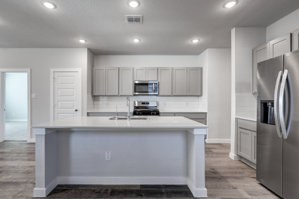 A kitchen with white cabinets.