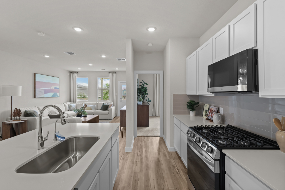 A kitchen with white cabinets.