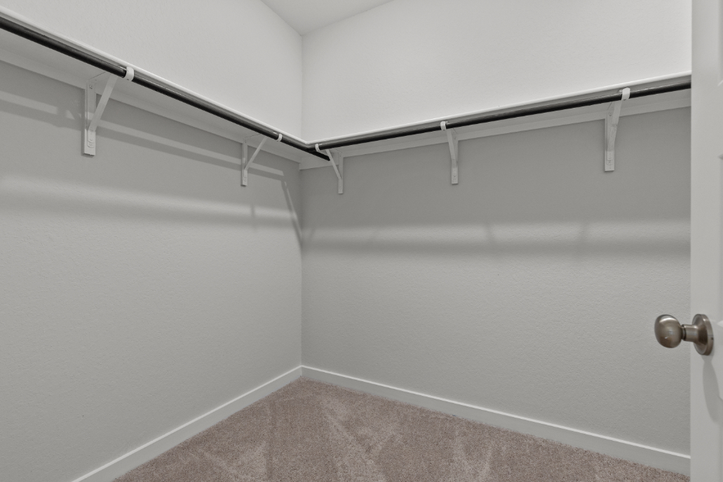 A white wall with a metal railing.