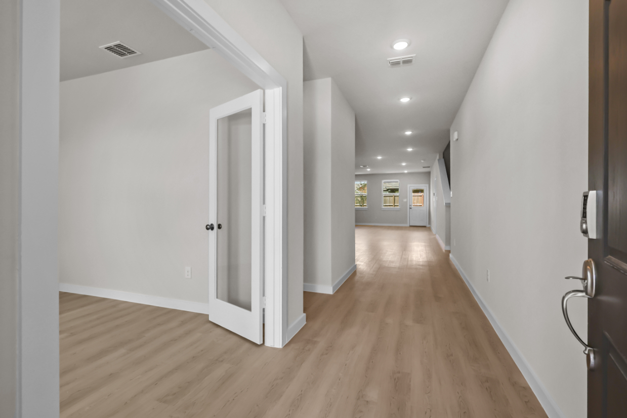 A hallway with white doors.