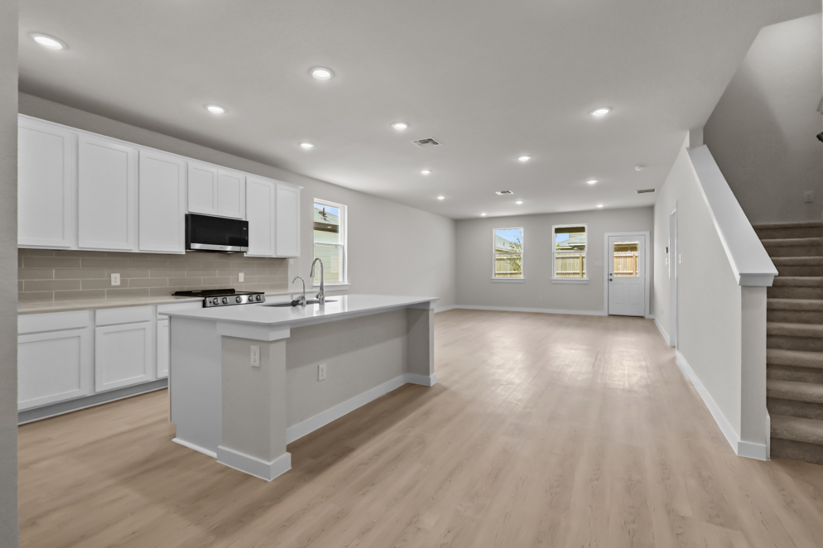 A kitchen with white cabinets.