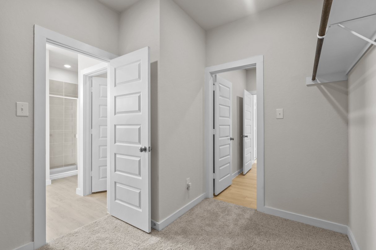 A hallway with white doors.
