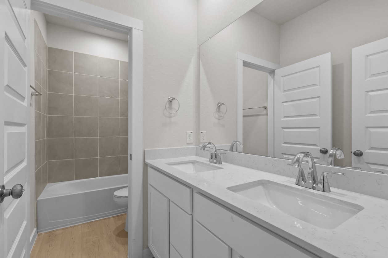 A bathroom with a tub sink and toilet.