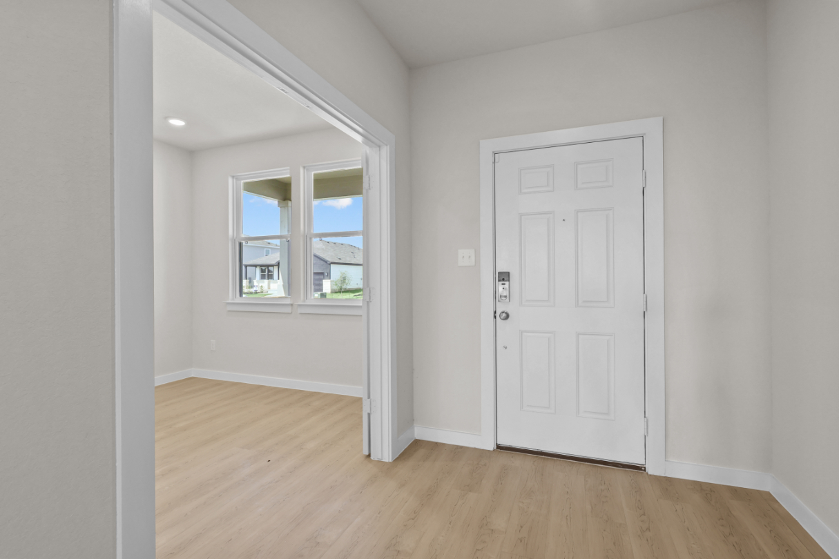 A room with a white door and a window.