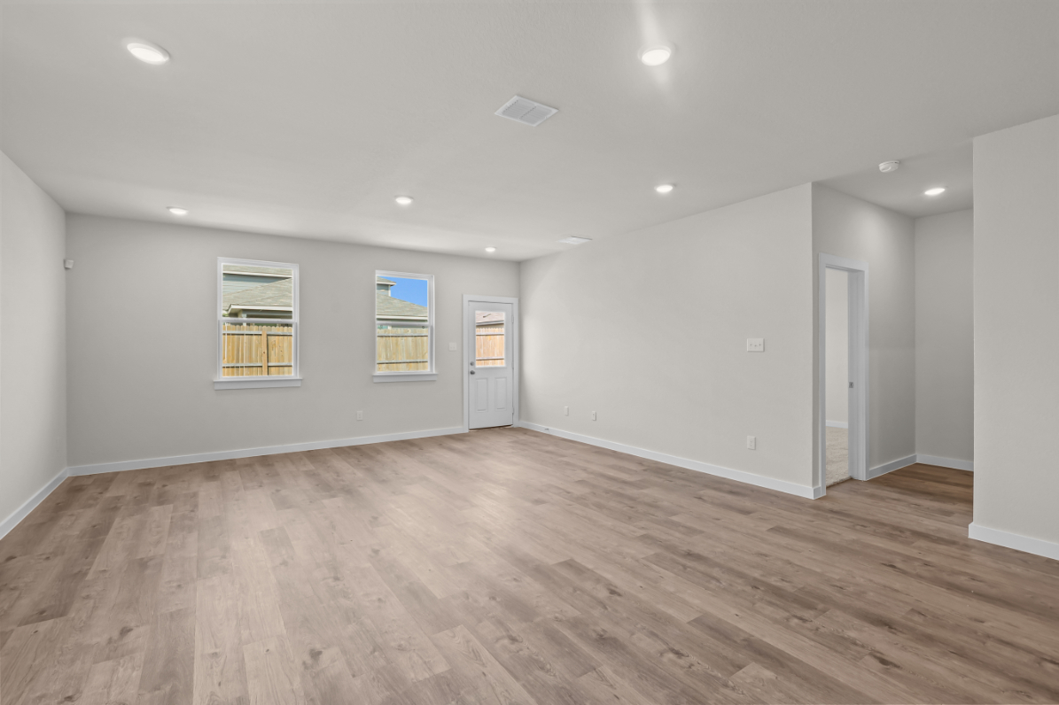 A room with a wood floor and white walls.