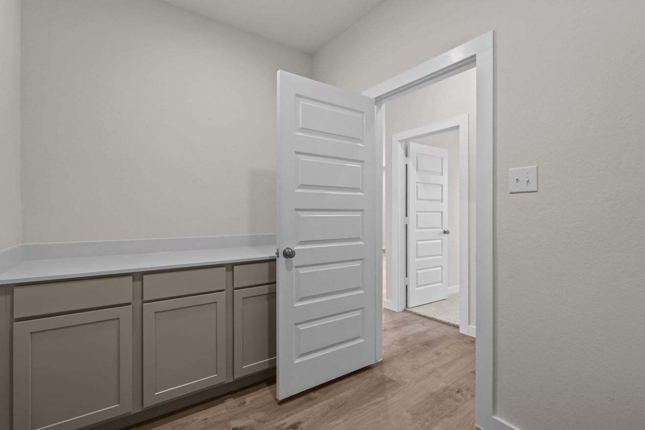 A room with white cabinets.