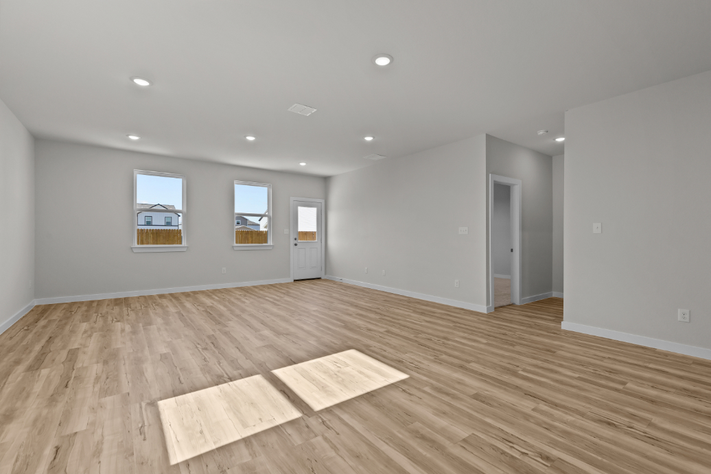 A room with a wood floor and a rug in it.