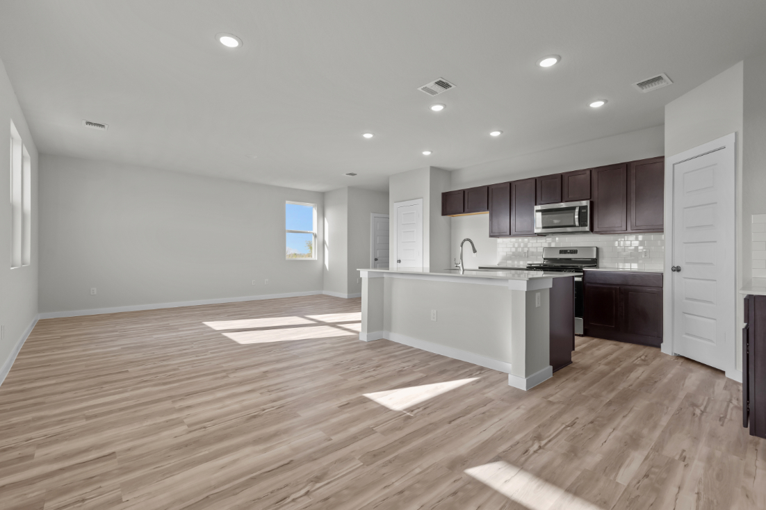 A kitchen with wooden floors.