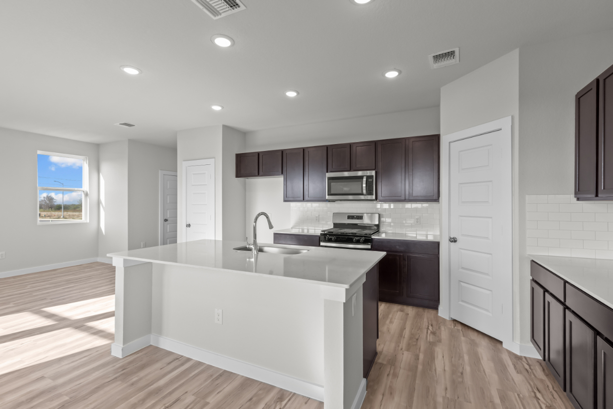 A kitchen with a white counter top.