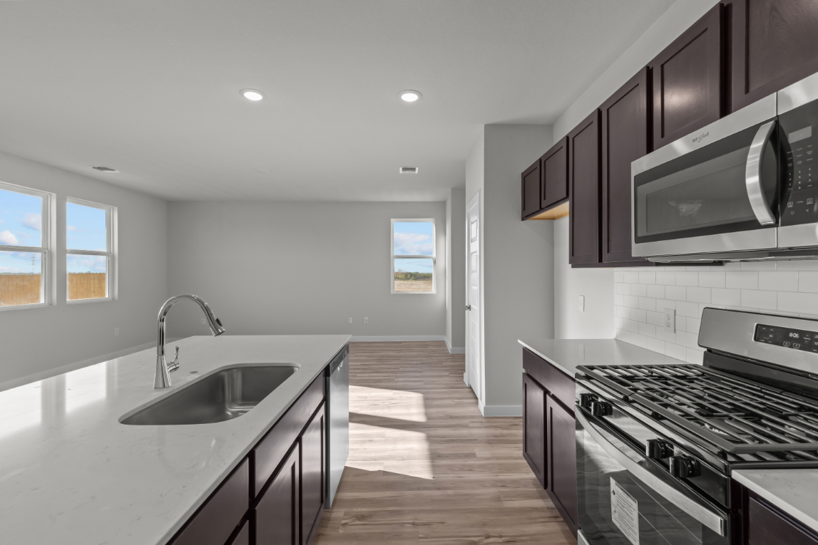 A kitchen with black cabinets.