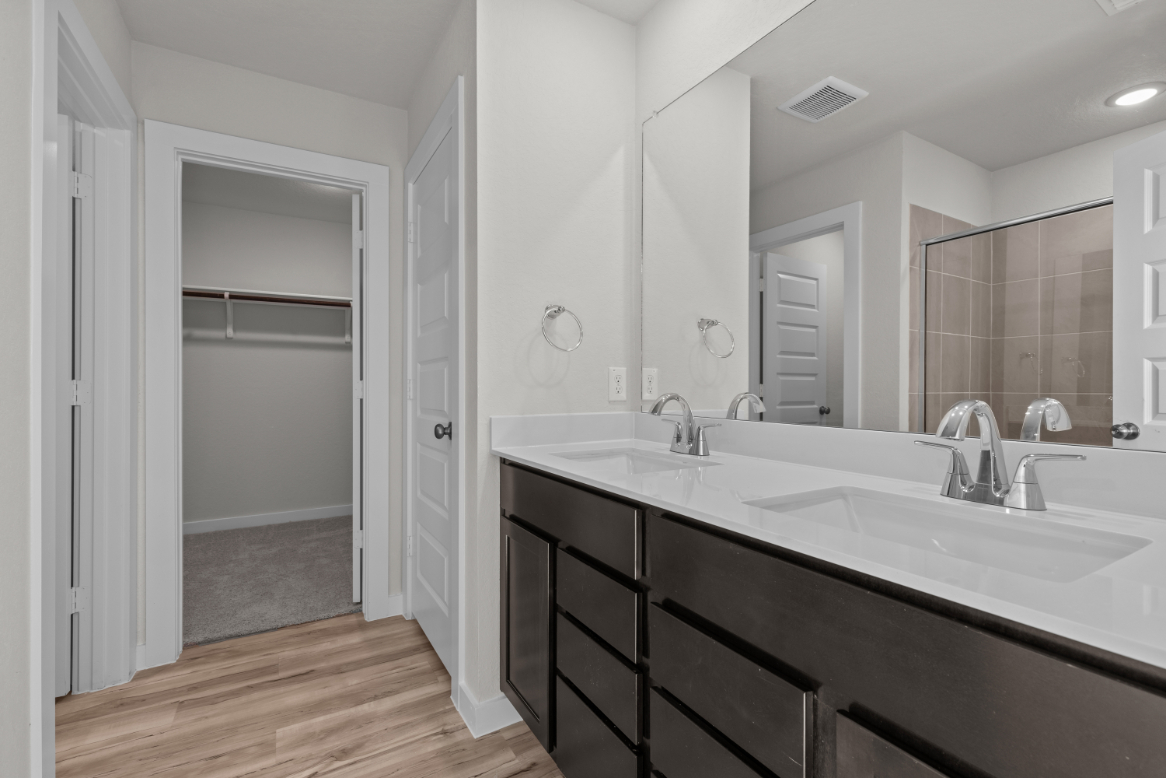 A bathroom with a large mirror.
