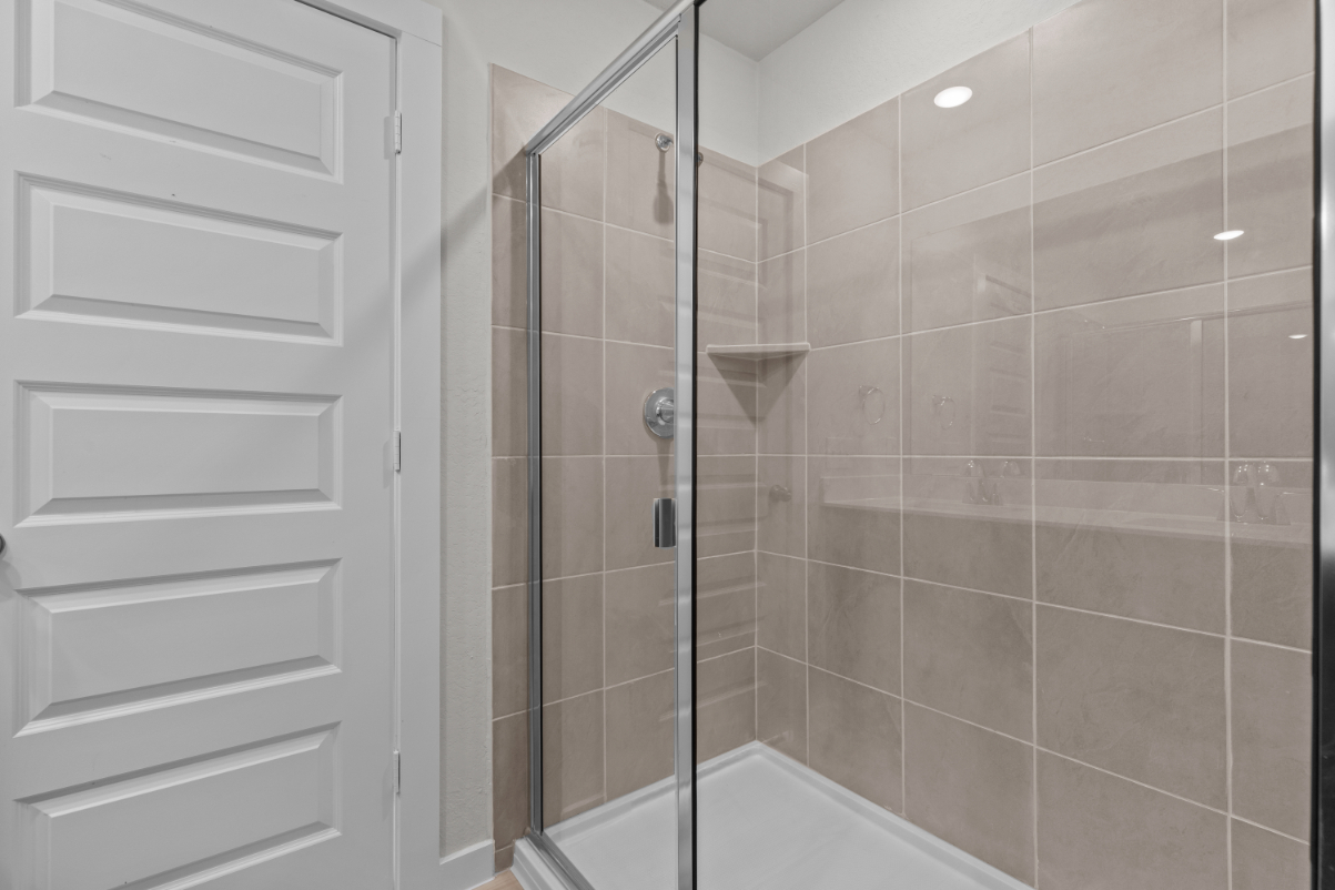 A shower with a glass door.