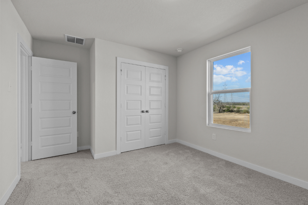 A room with white doors and a window.