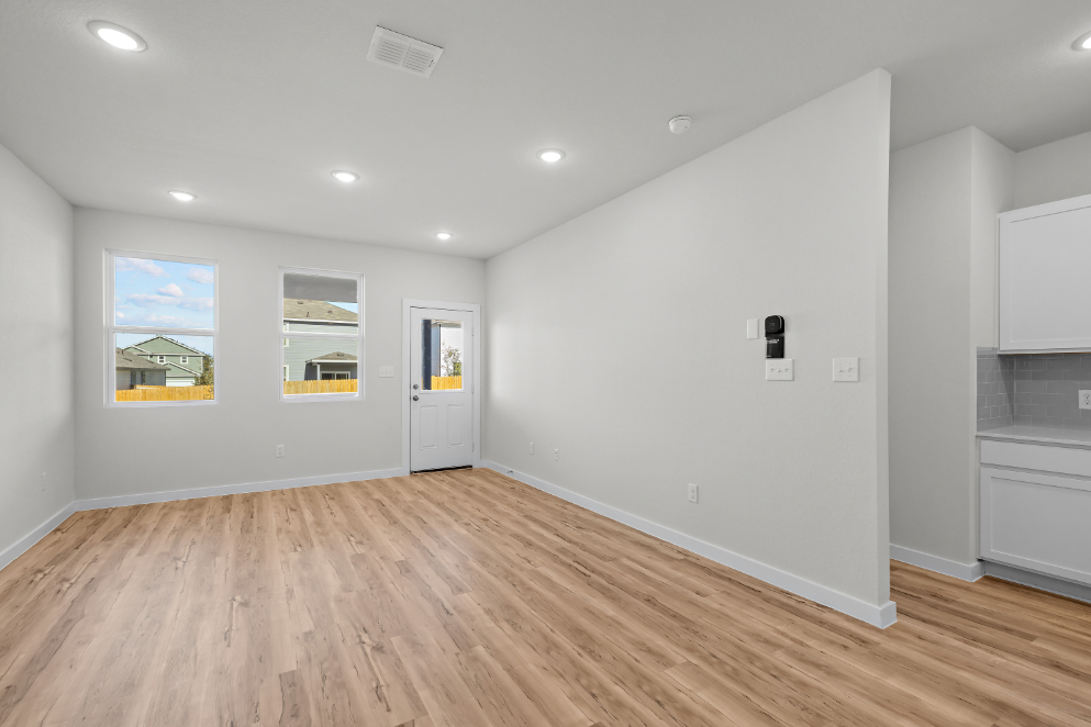 A room with white walls and a wood floor.