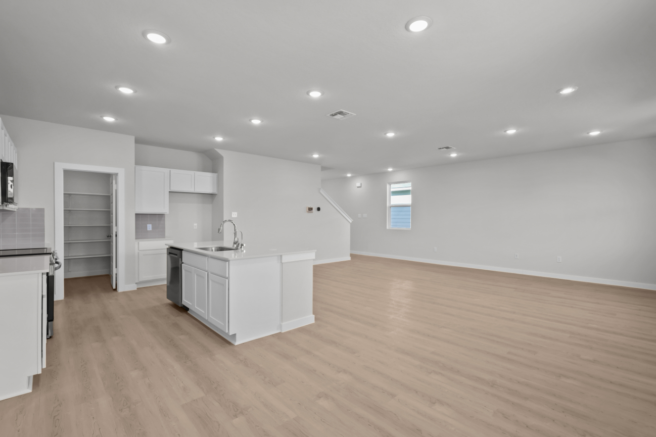 A kitchen with white cabinets.