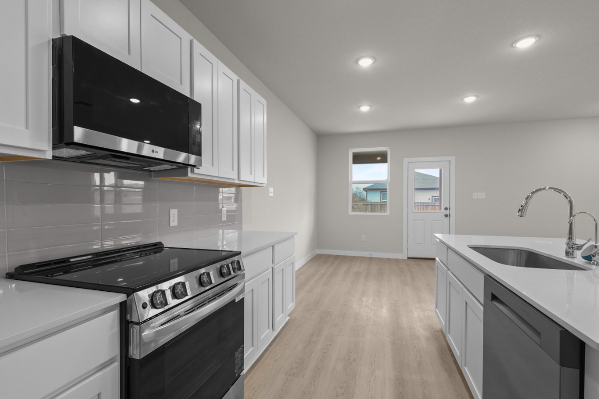 A kitchen with white cabinets.