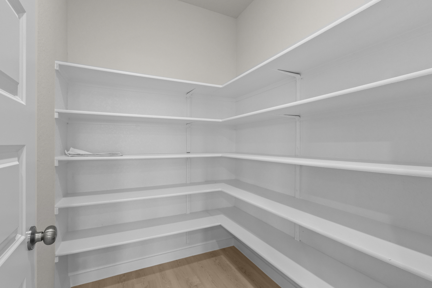 A white staircase with a wooden floor.