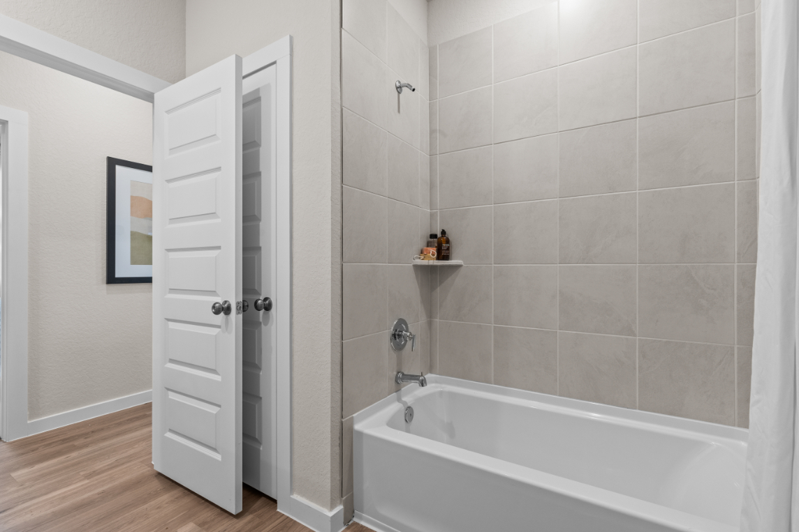 A bathroom with a white shower.