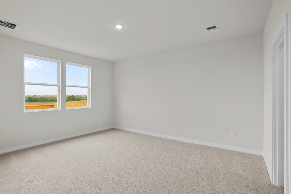 A room with a window and a carpet.