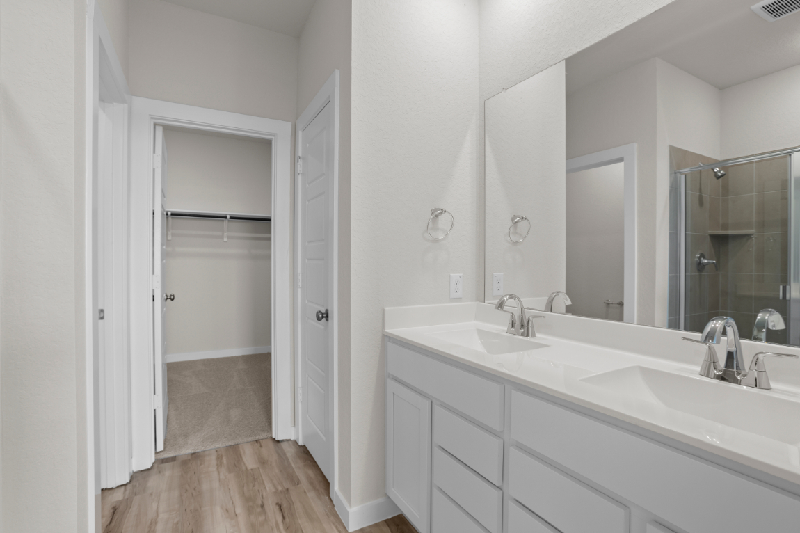 A bathroom with a large mirror.