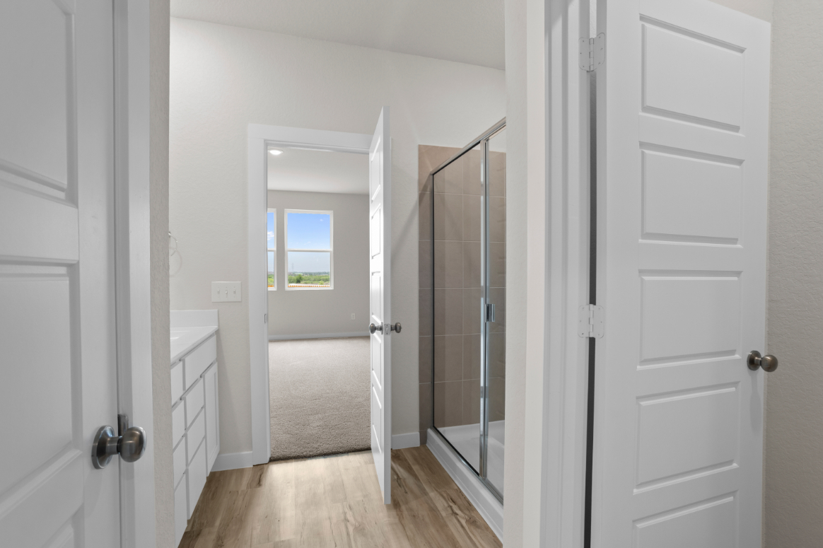 A bathroom with white doors.