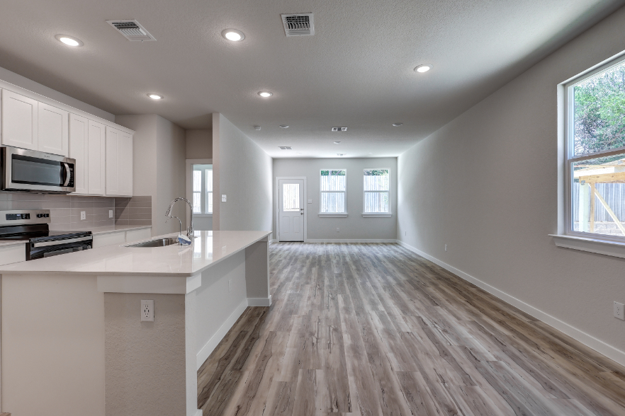 A kitchen with white cabinets.