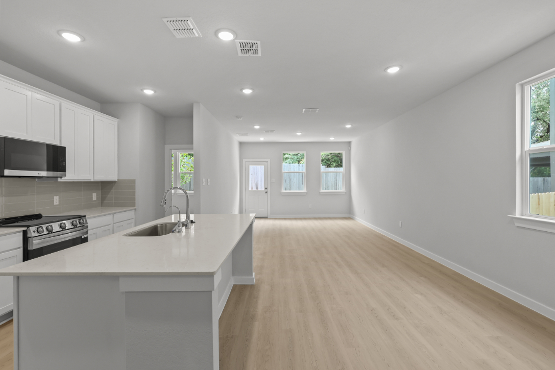 A kitchen with white cabinets.