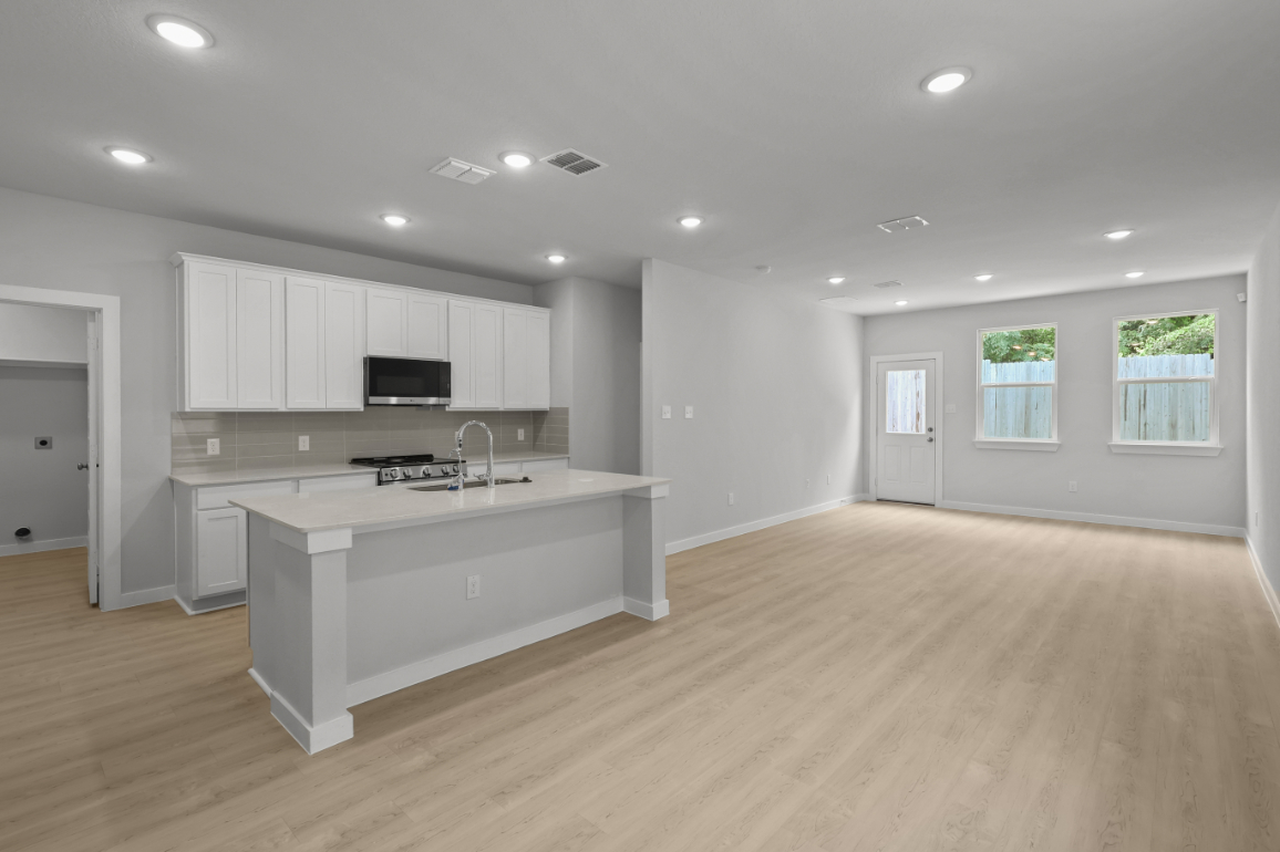 A large kitchen with white cabinets.