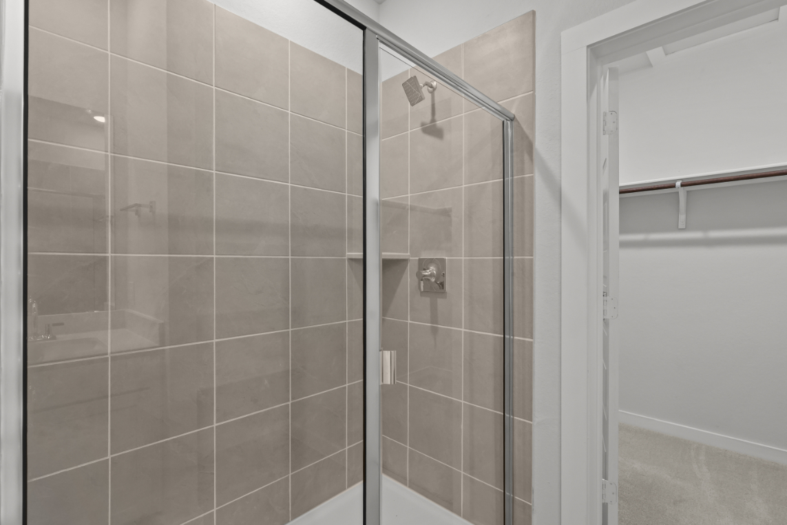 A shower with a glass door.