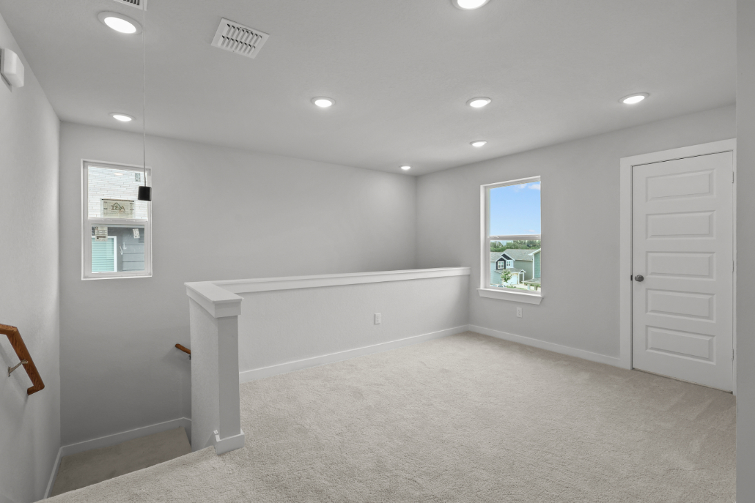 A room with a white bench and a window.