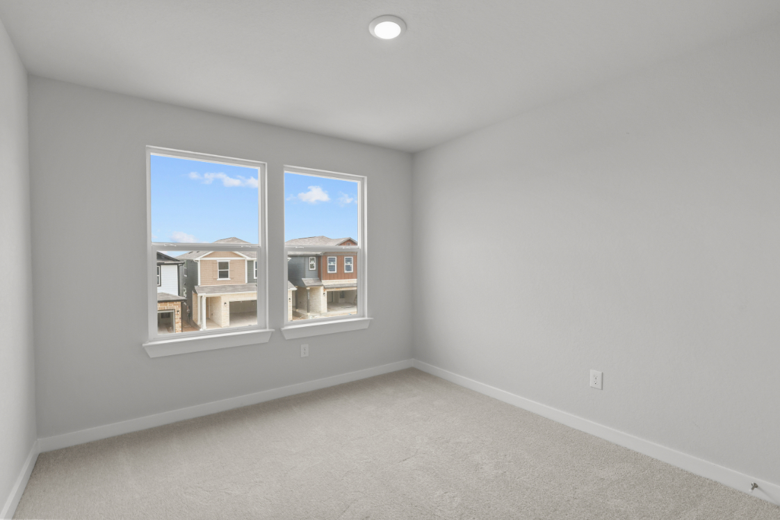 A room with a window and a view of the city.