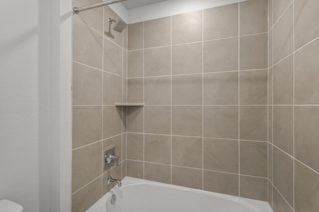 A bathtub in a bathroom.