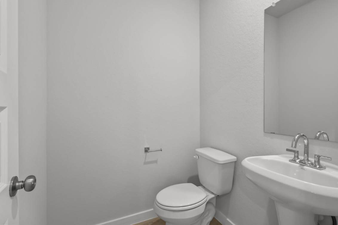 A bathroom with a toilet and sink.