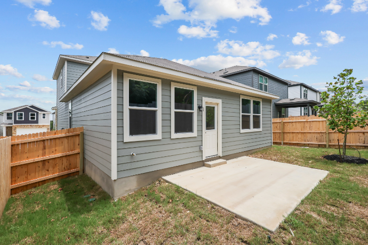 A house with a fence and grass.