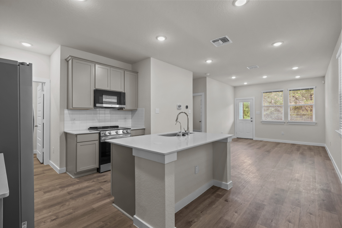 A kitchen with white cabinets.