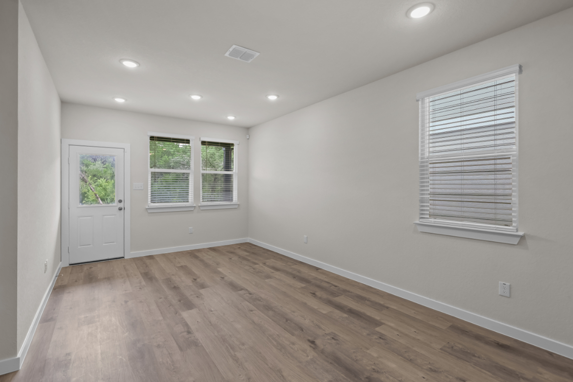 A room with a wood floor and white walls.