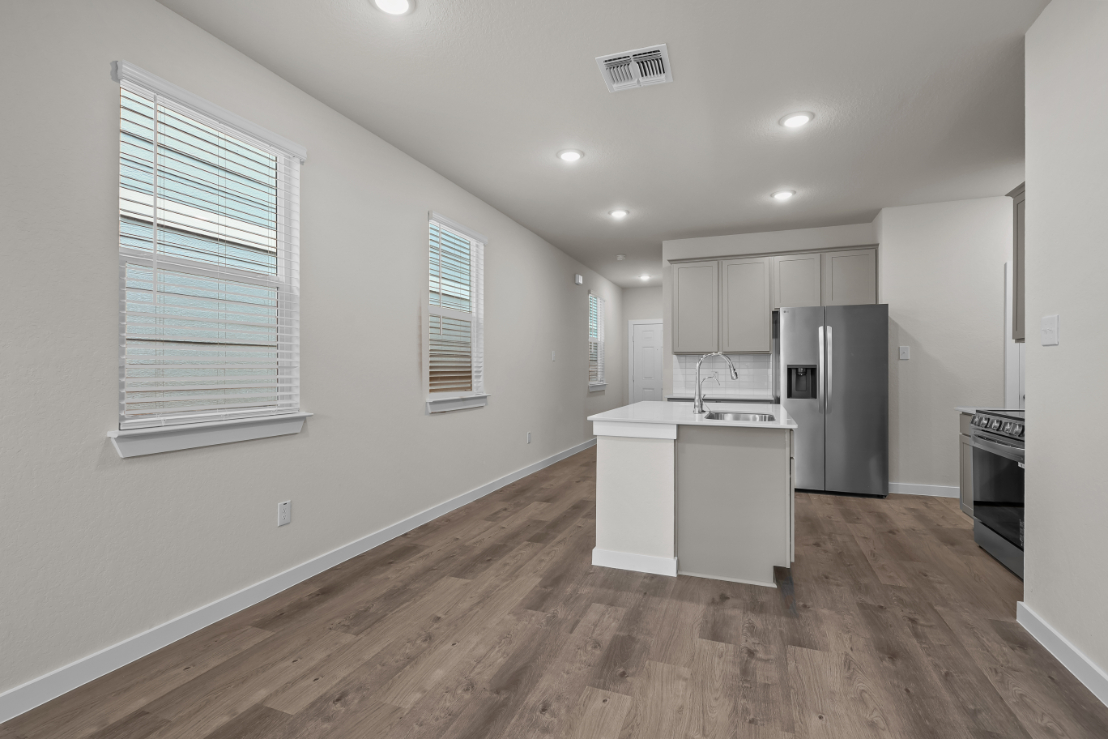 A kitchen with white cabinets.