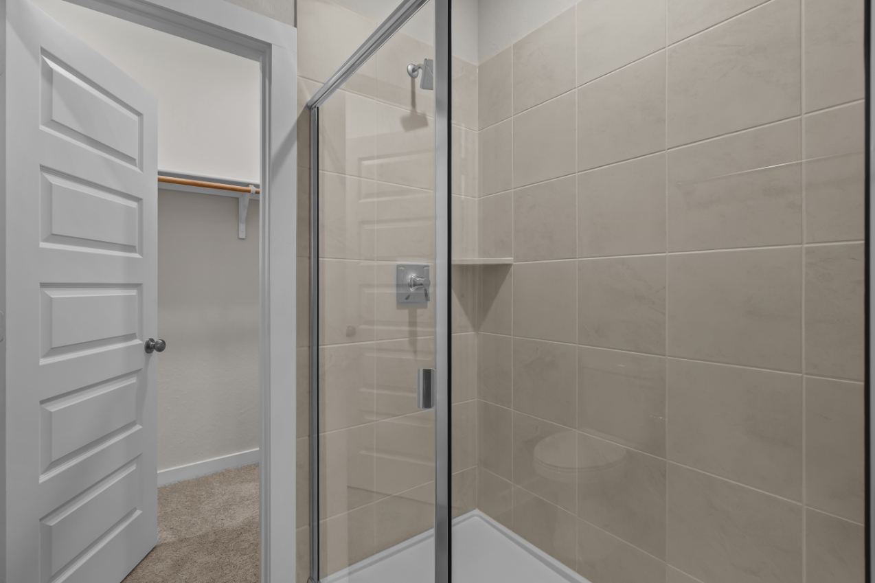 A shower with a glass door.