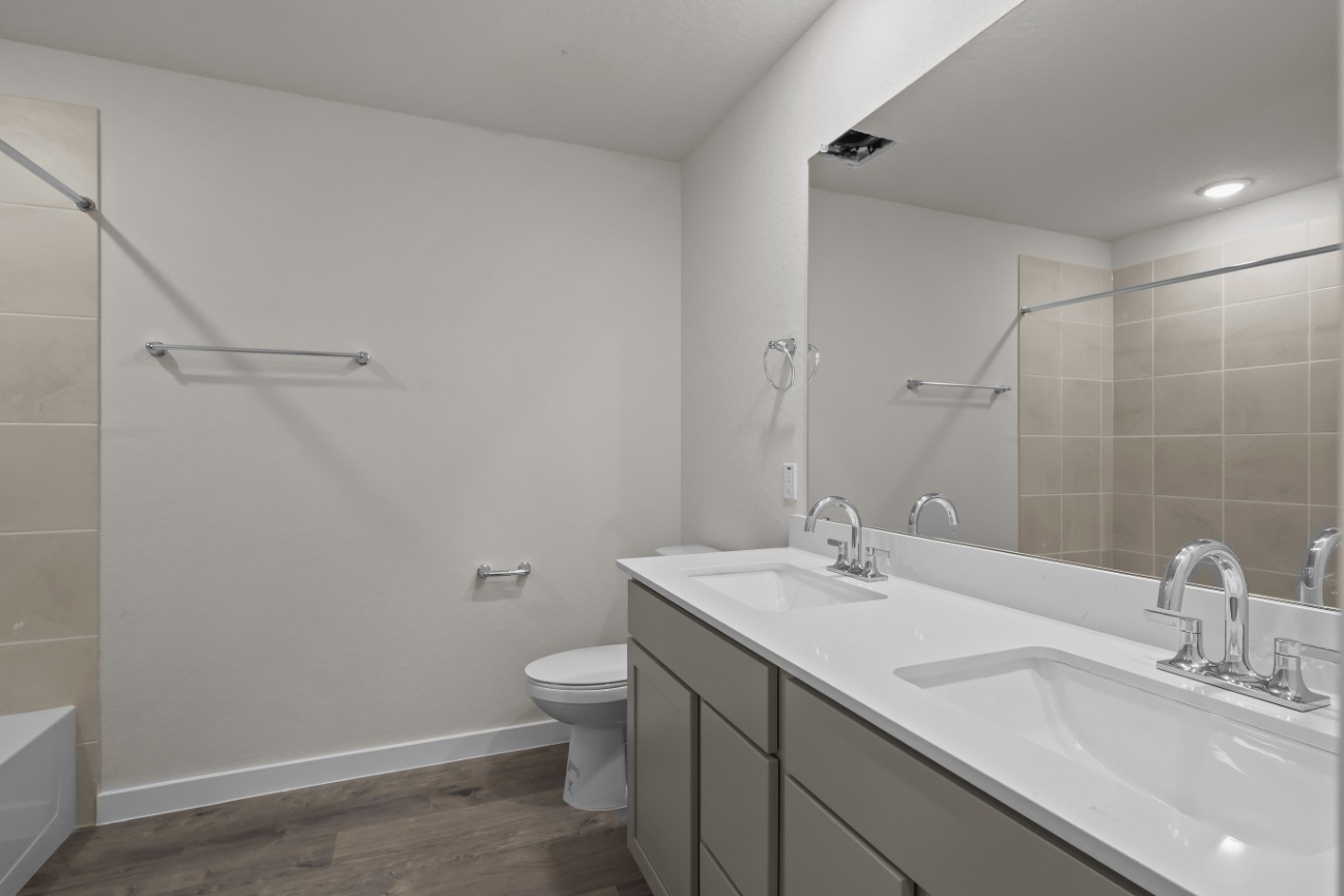 A bathroom with a large mirror.