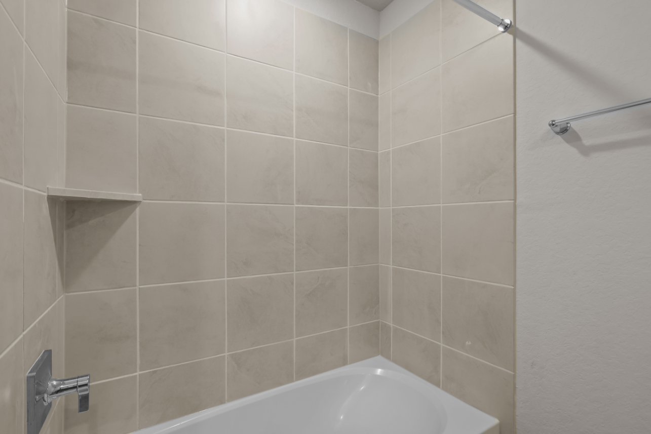 A bathtub in a bathroom.
