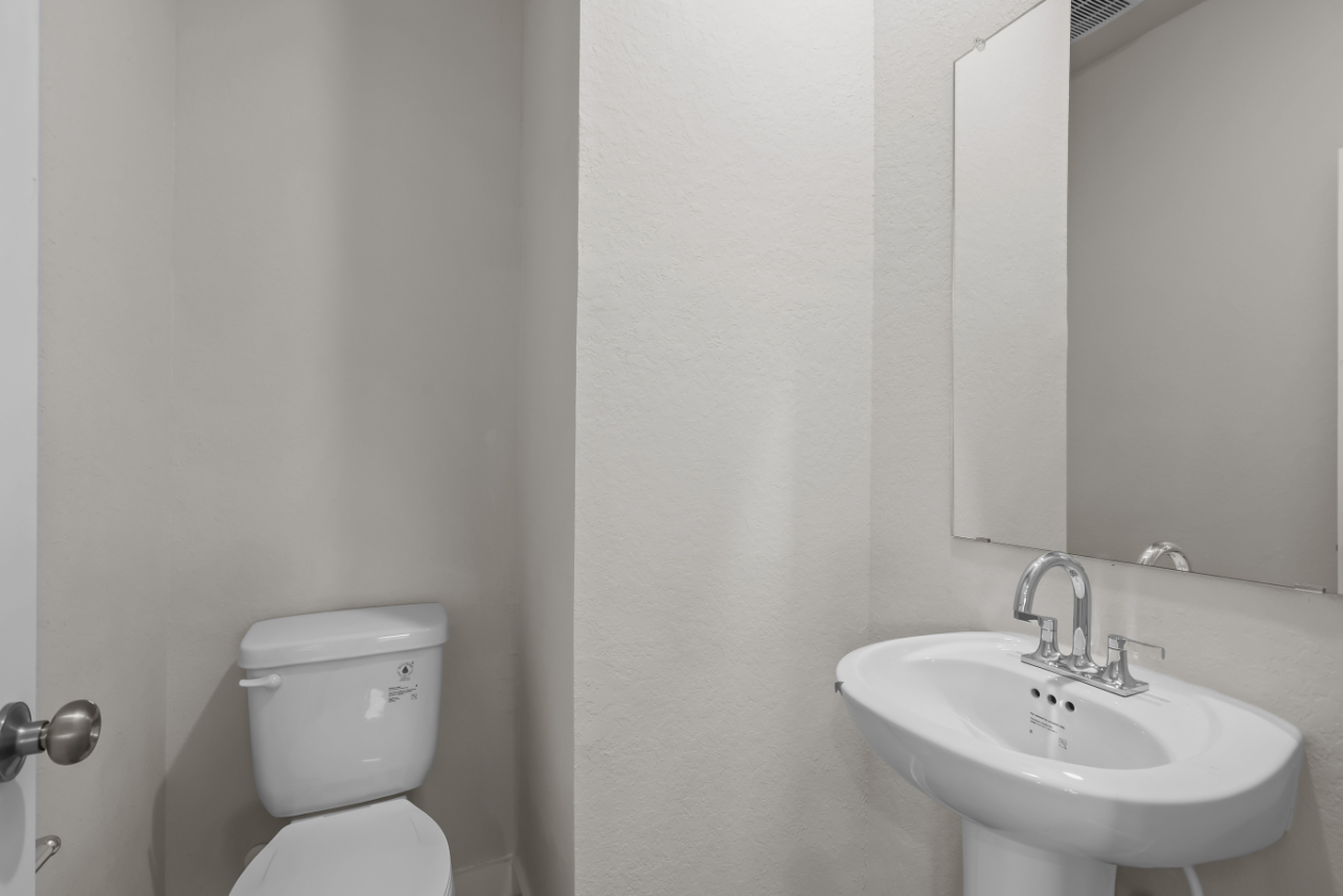 A bathroom with a toilet and sink.