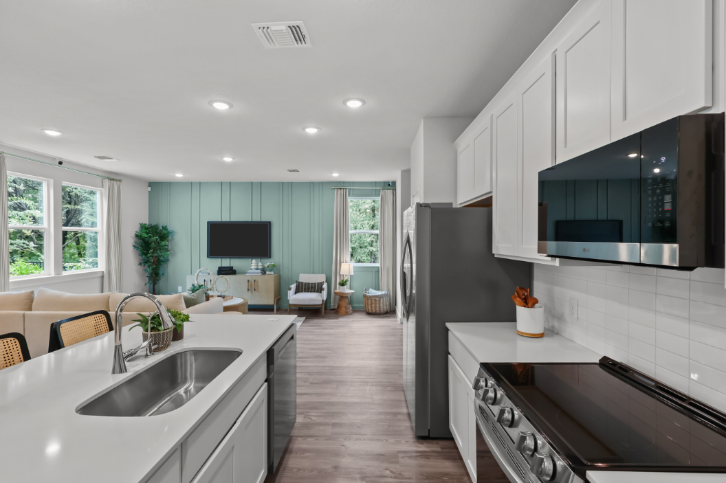 A kitchen with white cabinets.