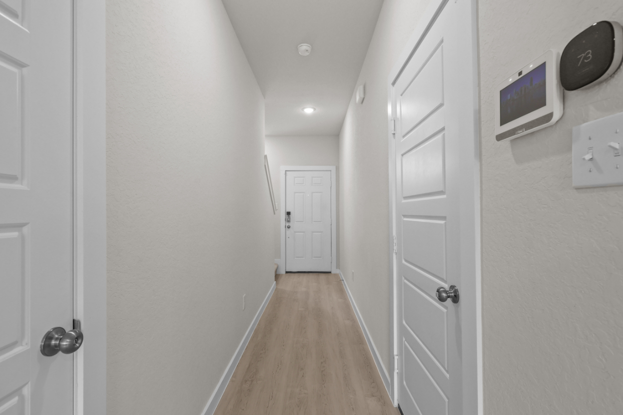 A hallway with white doors.