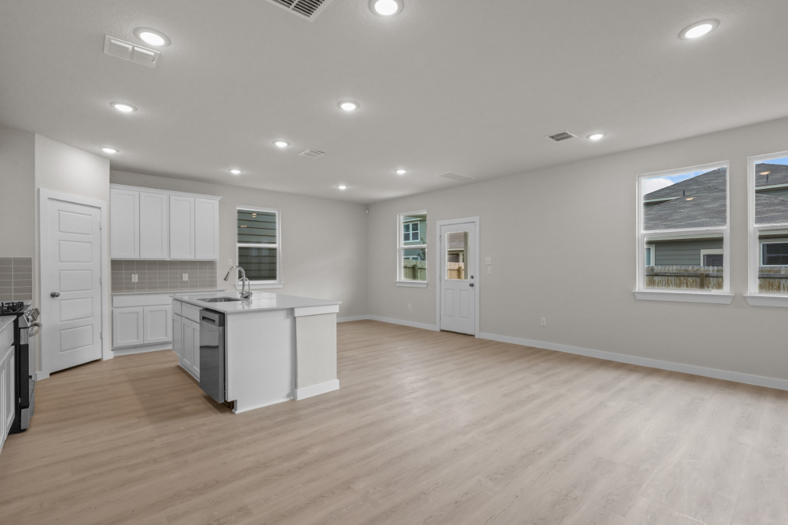 A large kitchen with white cabinets.