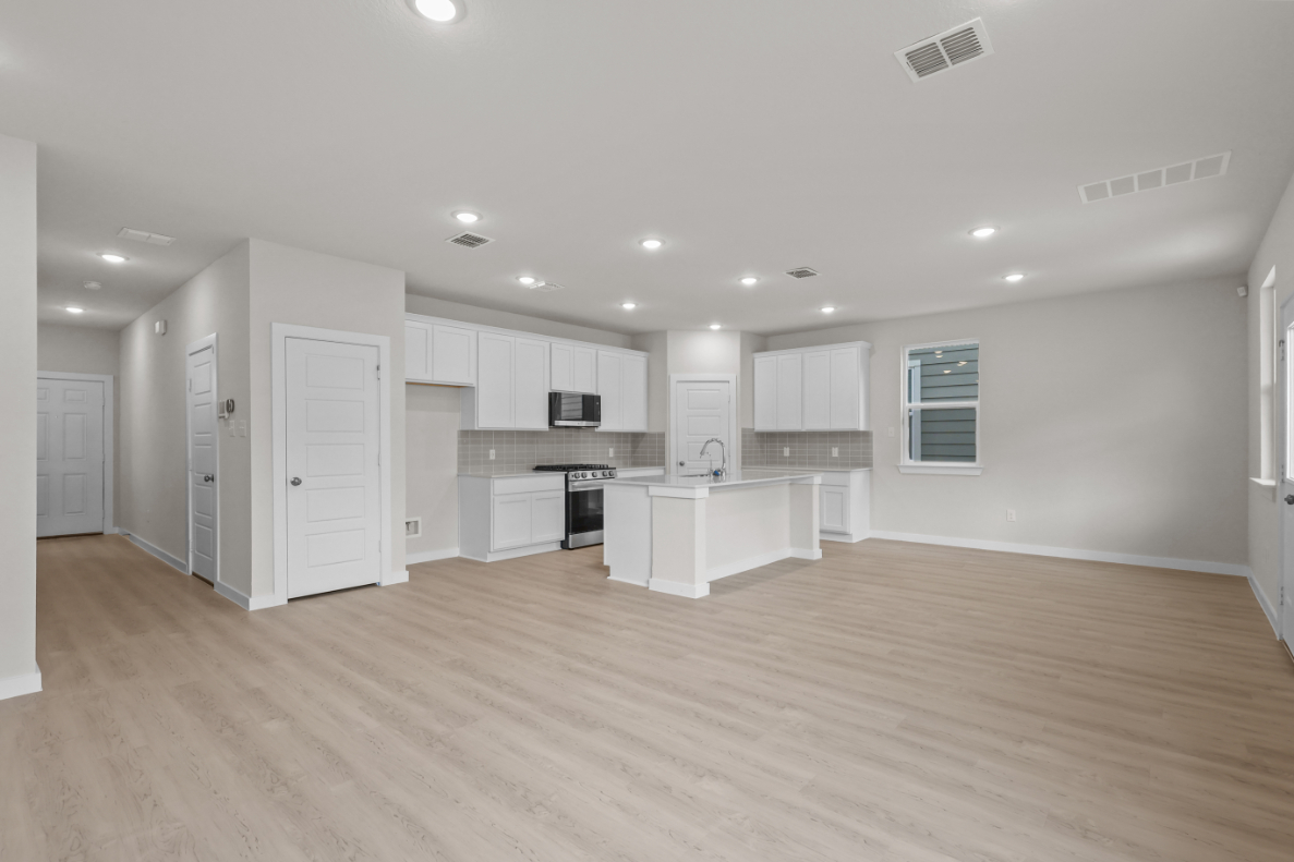 A large kitchen with white cabinets.