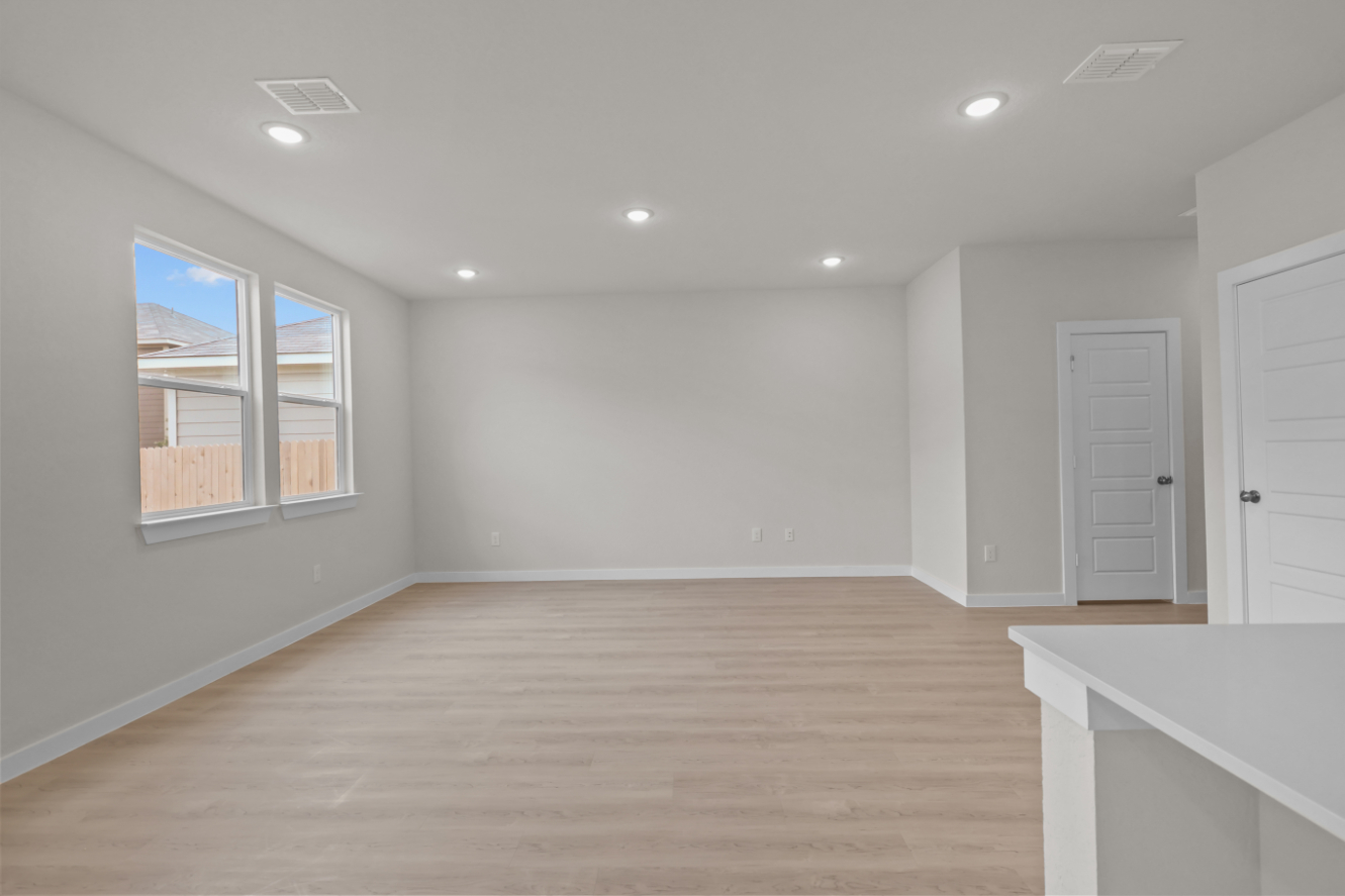 A room with white walls and a wood floor.